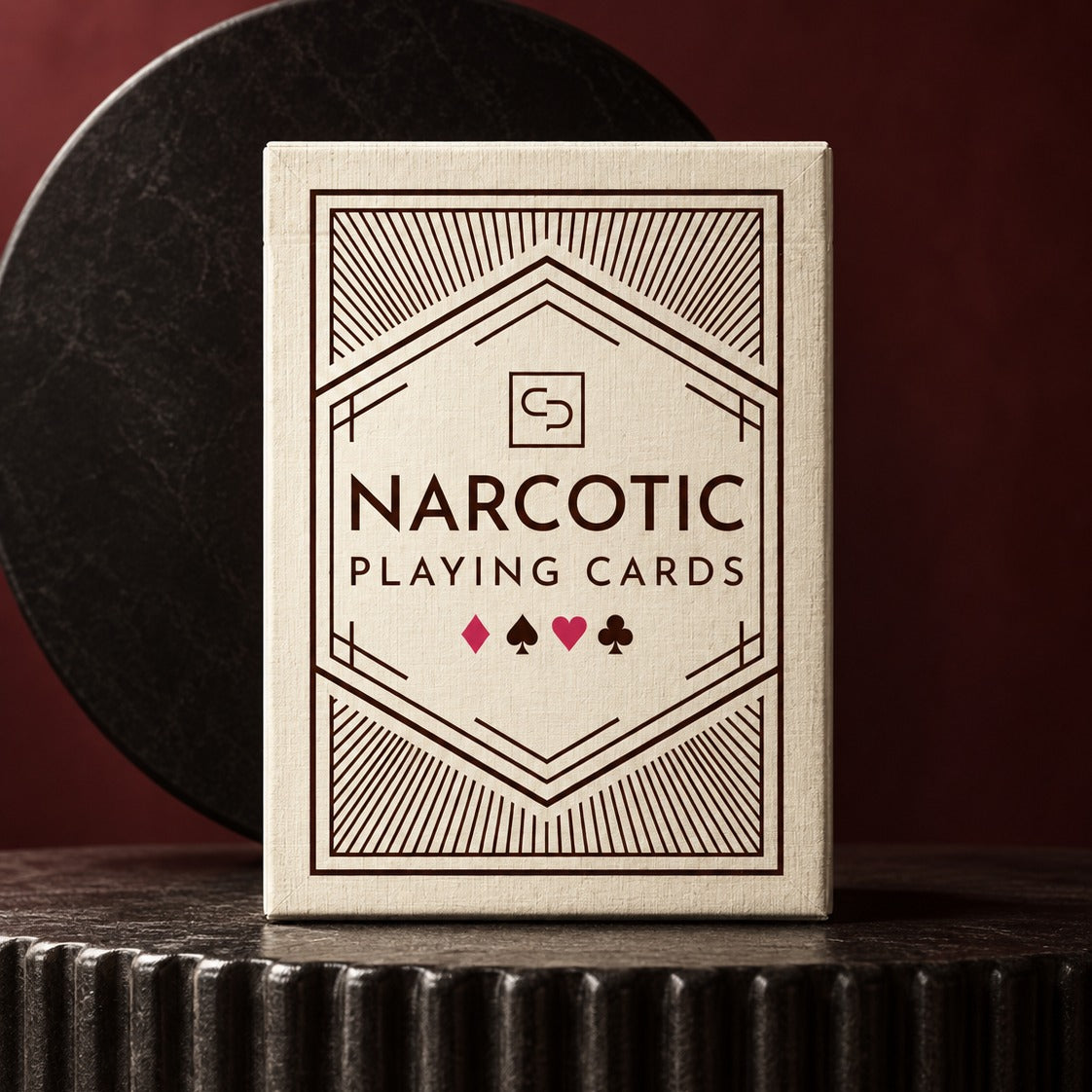 The Narcotic Playing Cards tuck box, bone and oxblood, on a fluted pedestal